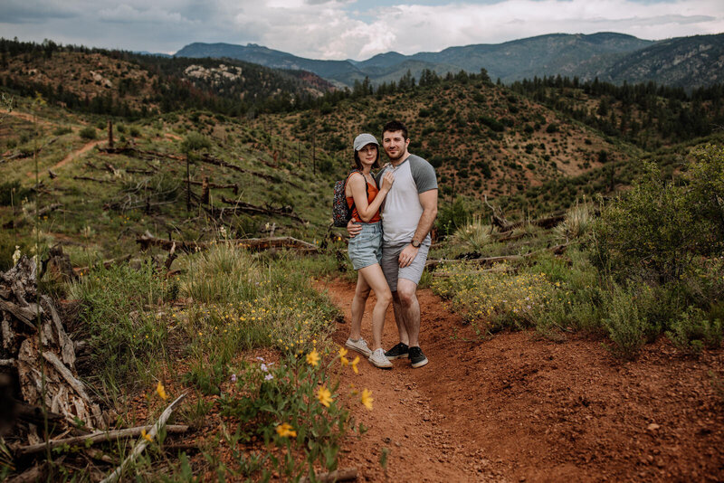 man and woman standing next to ocean
