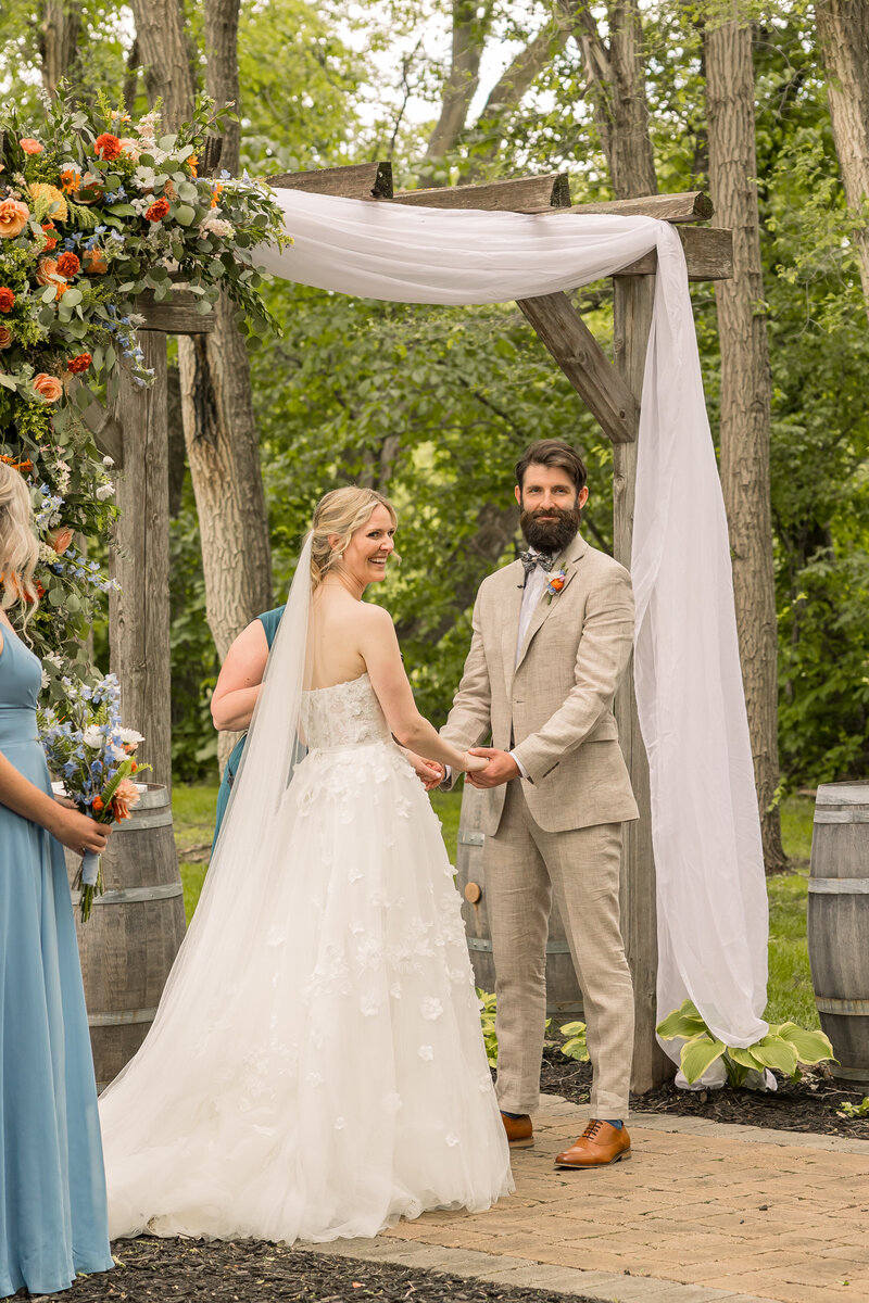 Wedding photo of bride and groom at the alter outside at Carlos Creek Winery in Alexandria Minnesota