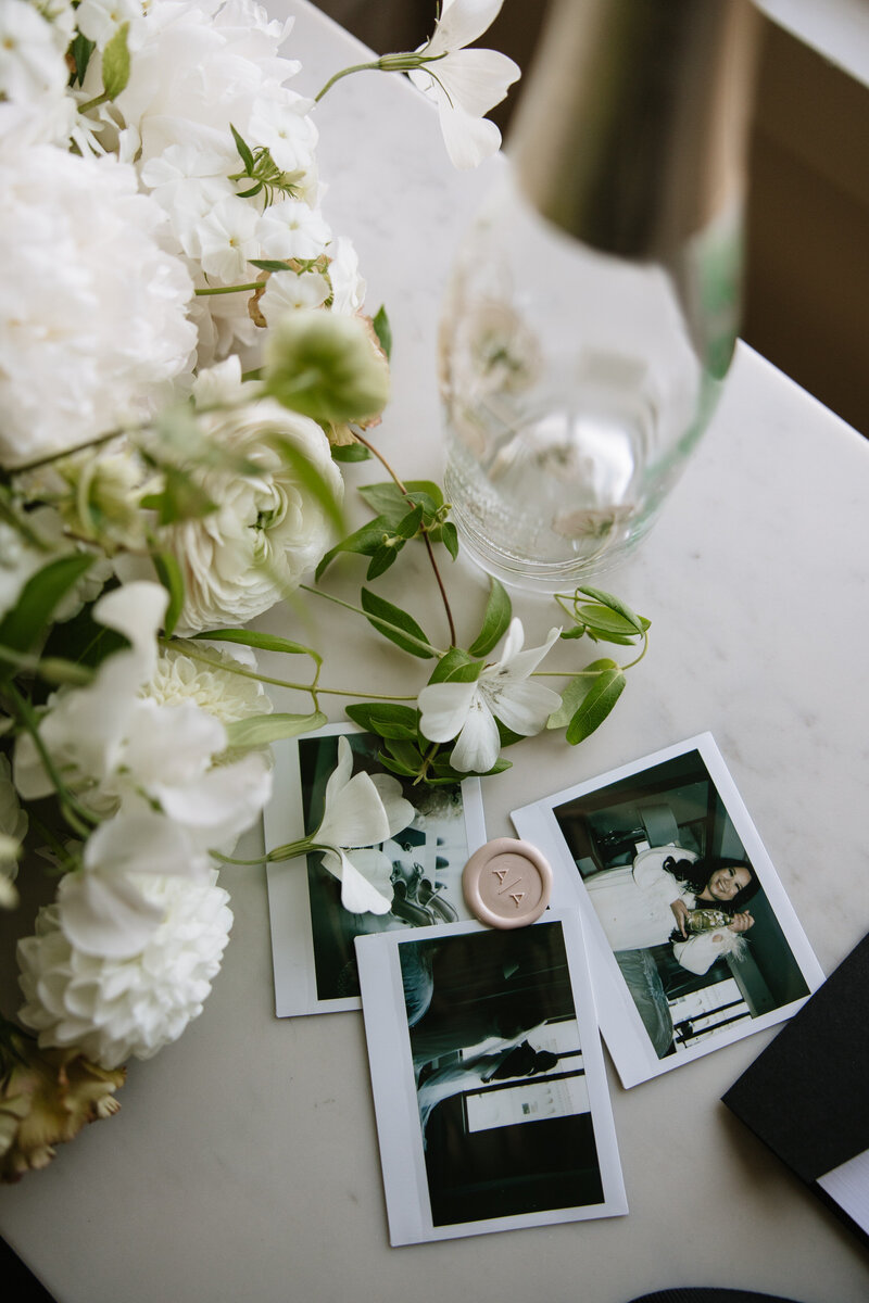 Flatlay of wedding rings, florals, and vow books styled by San Francisco wedding photographer Erica Rochelle
