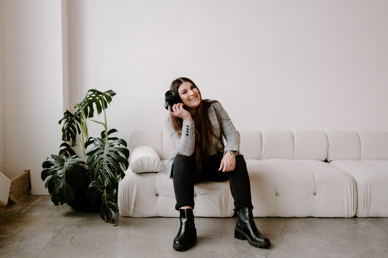 photographer sits on couch