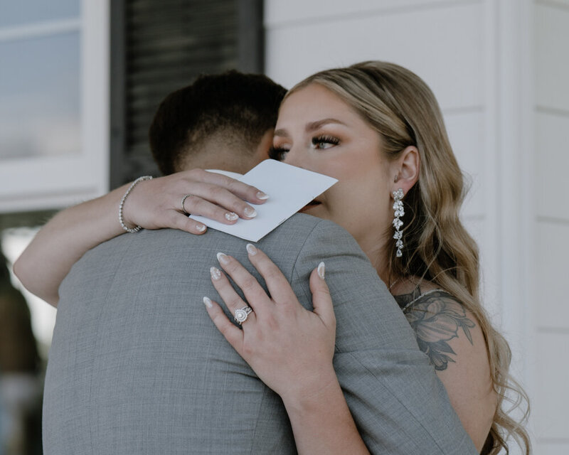 bride and groom hugging after the bride reads her vows