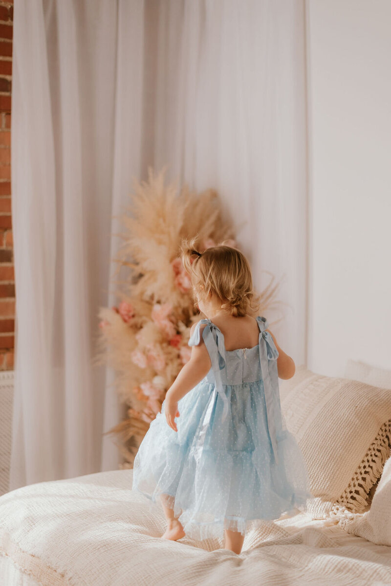 little girl plays during family photos in peoria il