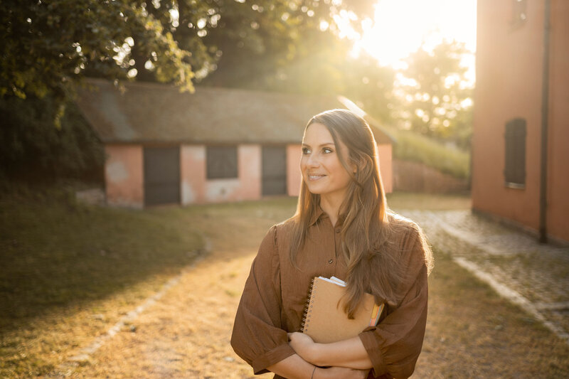 Barbora sits looking into the camera. She is a manifestation coach
