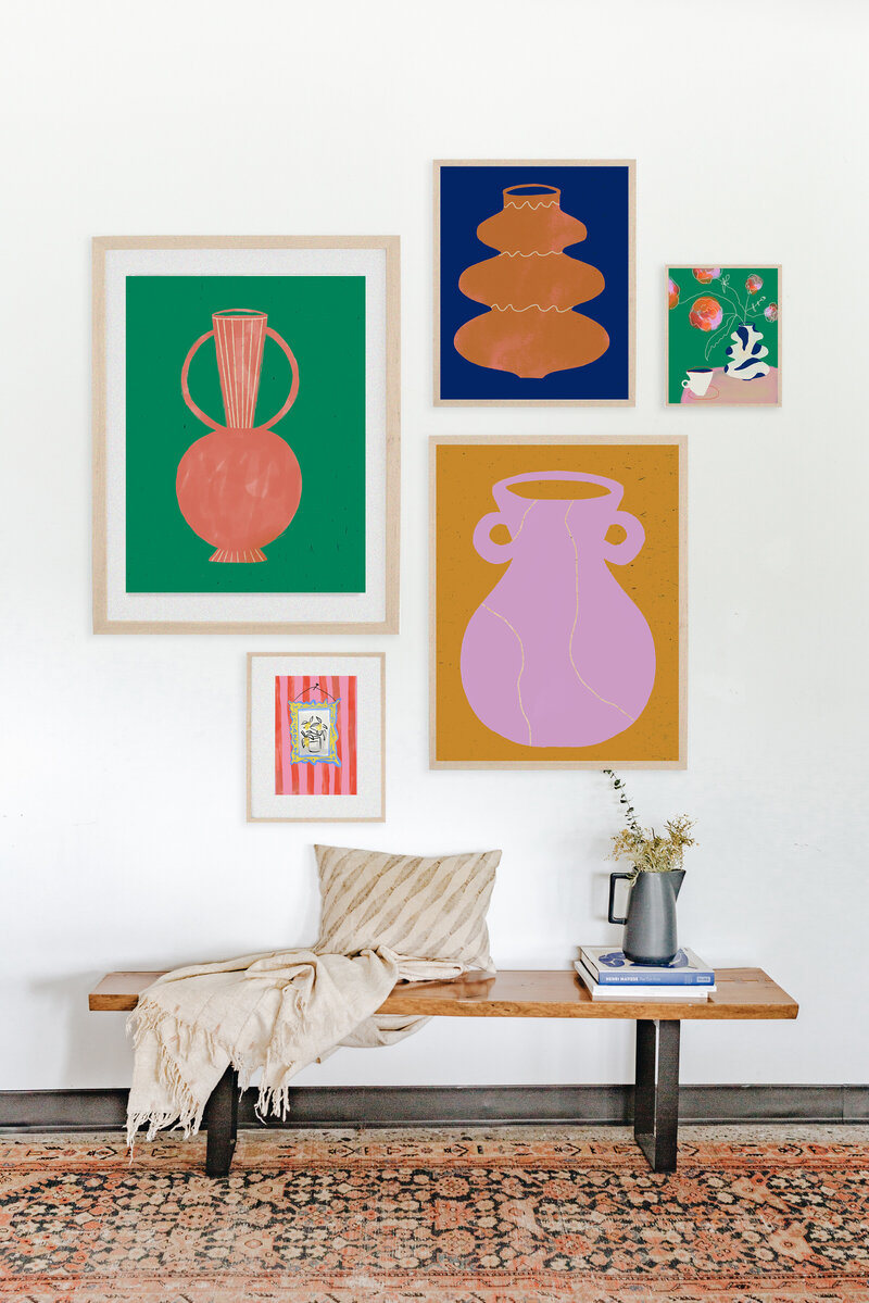 gallery wall of colorful prints on a white interior wall