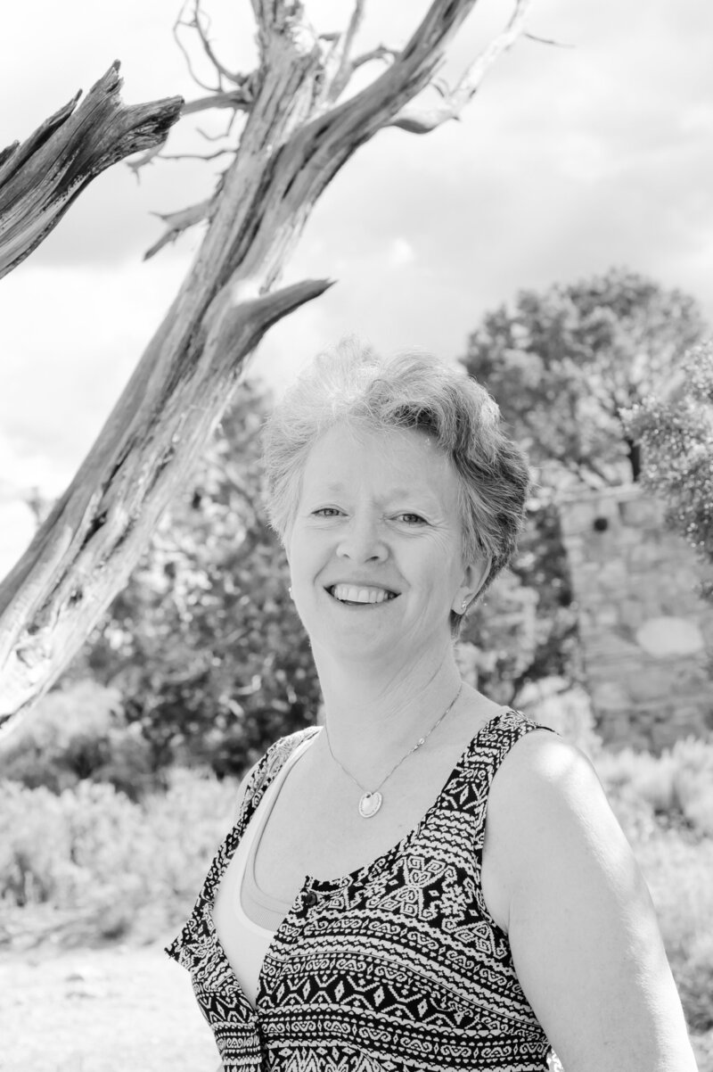 Portrait of Artist Cindy L Smith smiling and wearing black and white top