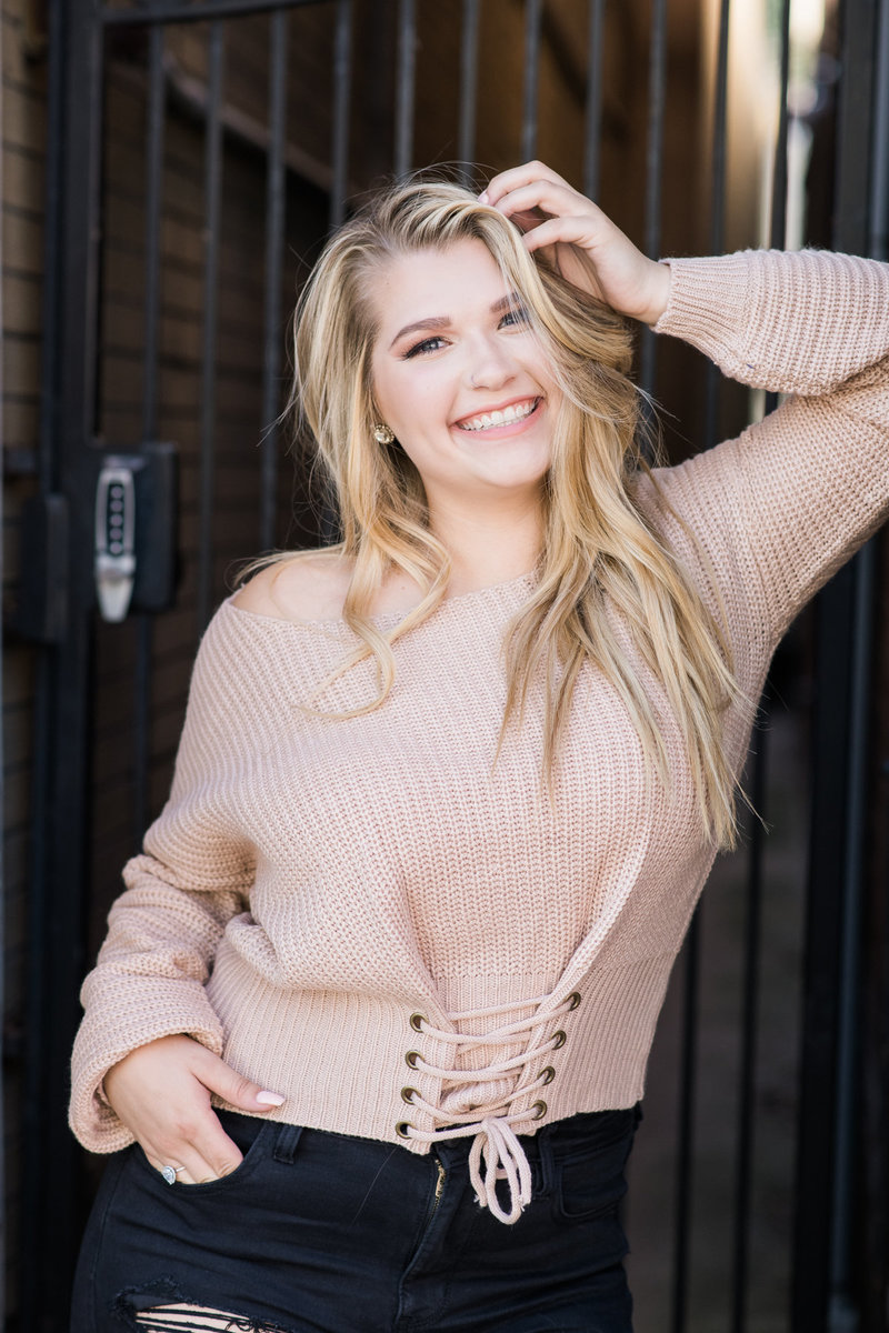 High school senior in downtown davenport, iowa with a pink sweater