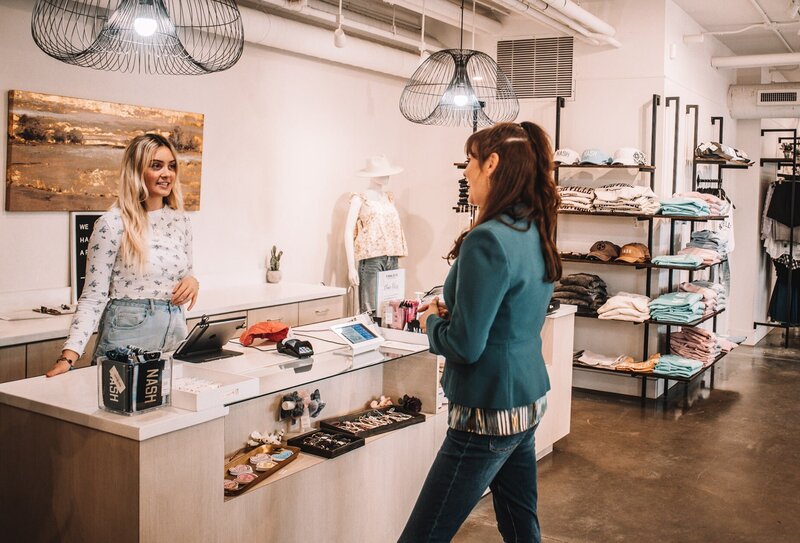 Brittany Hodak interacting with a sales associate at Finnleys in Nashville.