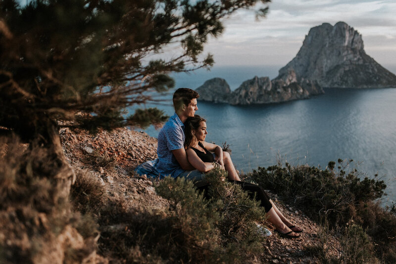 Devon Wedding Photographer Liberty Pearl Photography and her husband laying together atop a cliff with the sea in the background