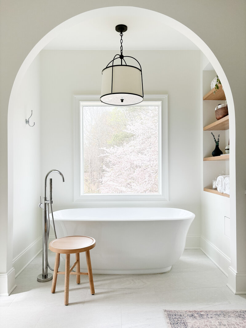 Luxury primary bathroom design in Milton, Georgia featuring a walk-in shower, freestanding tub, and elegant finishes by Megan Paterson Interiors.