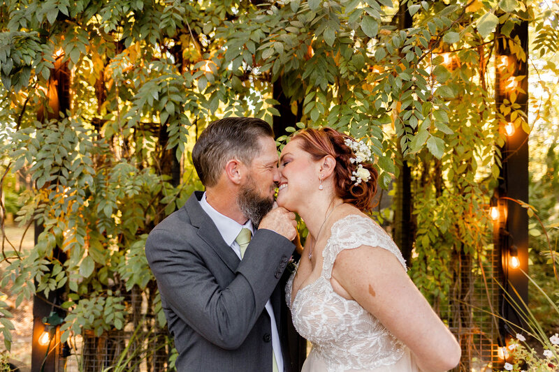 Just married couple sharing a joyful moment during their elopement at Marry Me Cottage in O’Fallon, MO, captured by Style & Grace Photography.