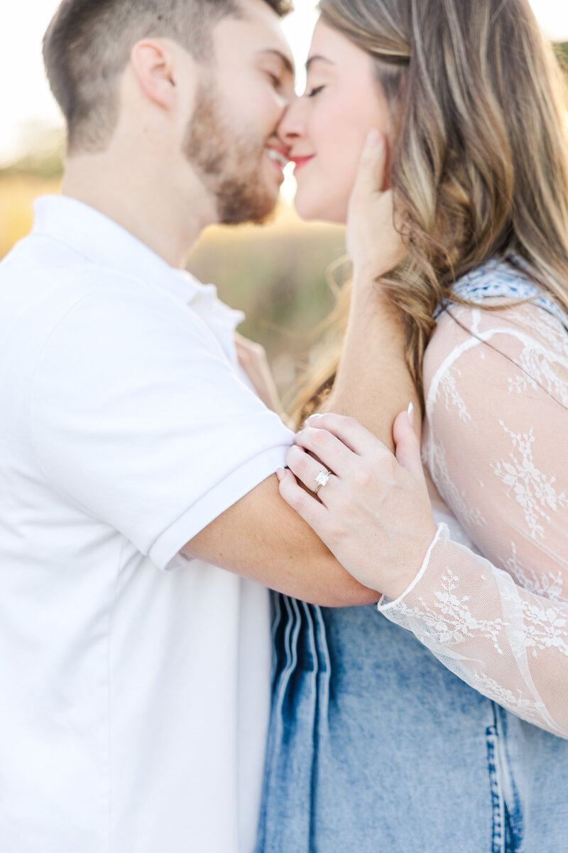 San Antonio wedding photographer captures bride and groom kissing in an airy field
