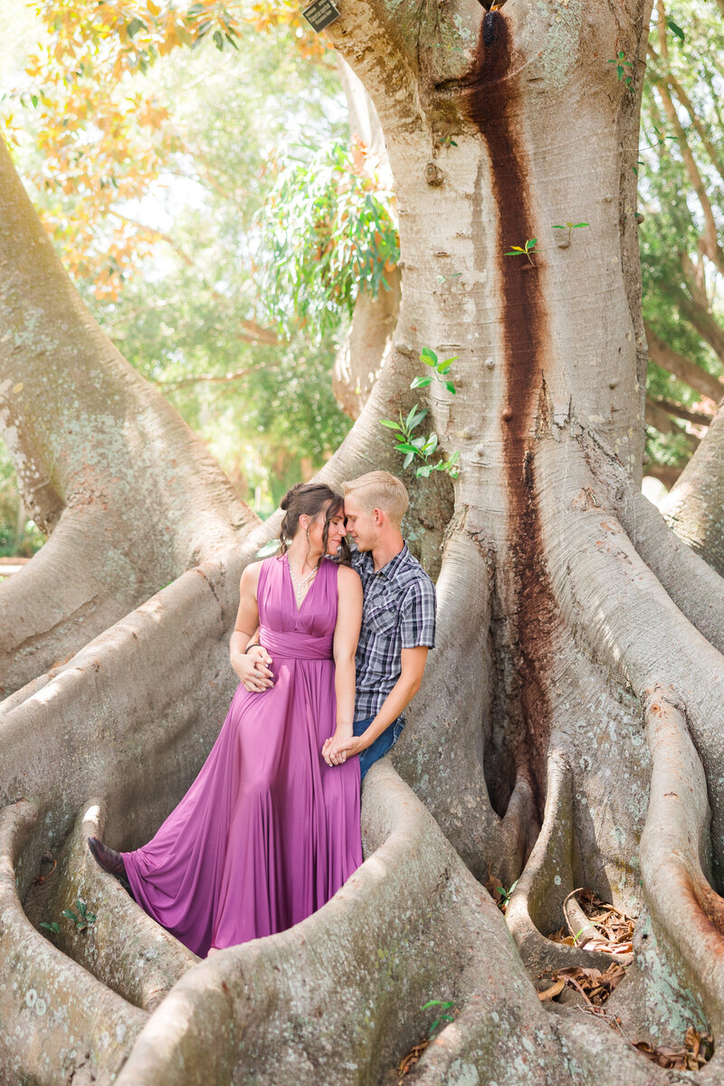 A couple embrace on a beach at one of the engagement photo spots on Sarasota Beach