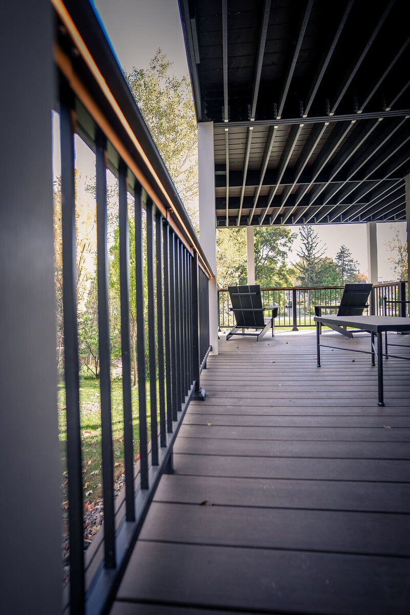 Lower private deck focusing on the LED strip lights routed into the drink rail on aluminum picket railing. 