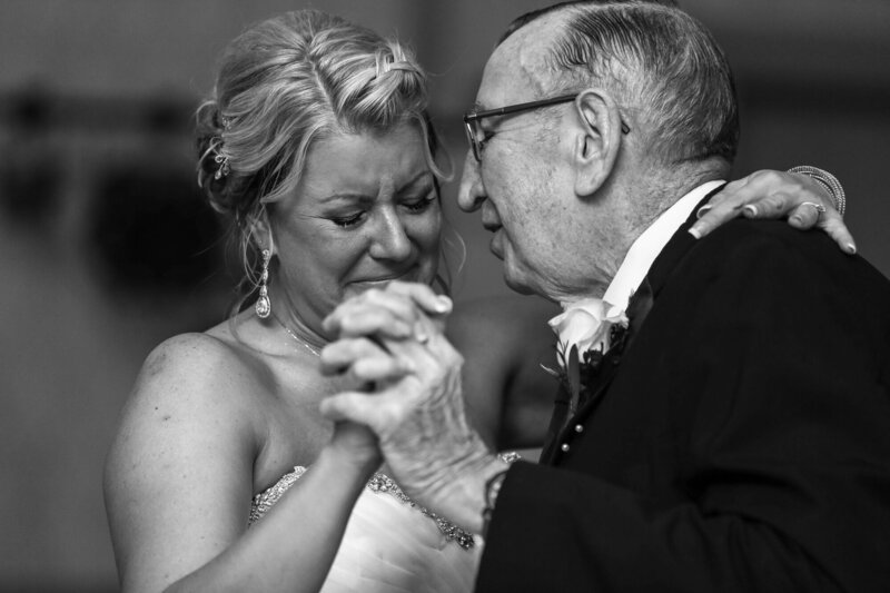 Bride begins to cry while dancing with her father at wedding reception at Lake Shore Country Club