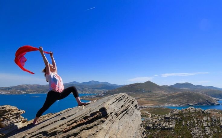 Yoga Teacher Poses on Cliff over Mediterranean