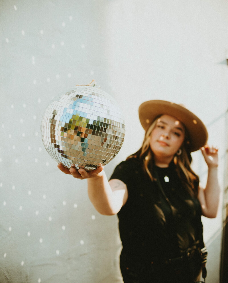 woman holding disco ball