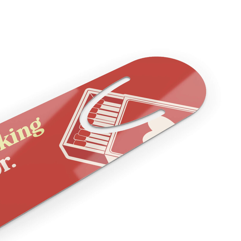 A cream and red bookmark that says Books worth licking your fingers for.