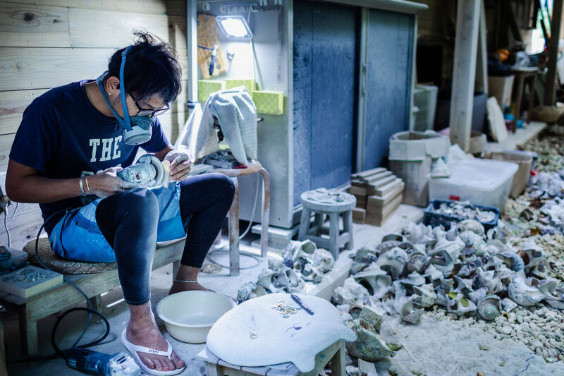 A shell jewelry artisan working in his atelier.