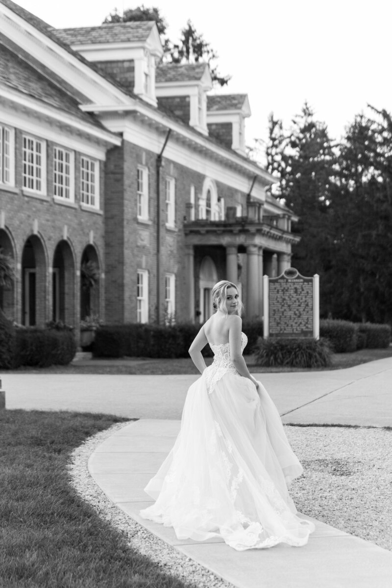 Caroline looking over her shoulder as she walks towards the Felt Mansion in West Michigan