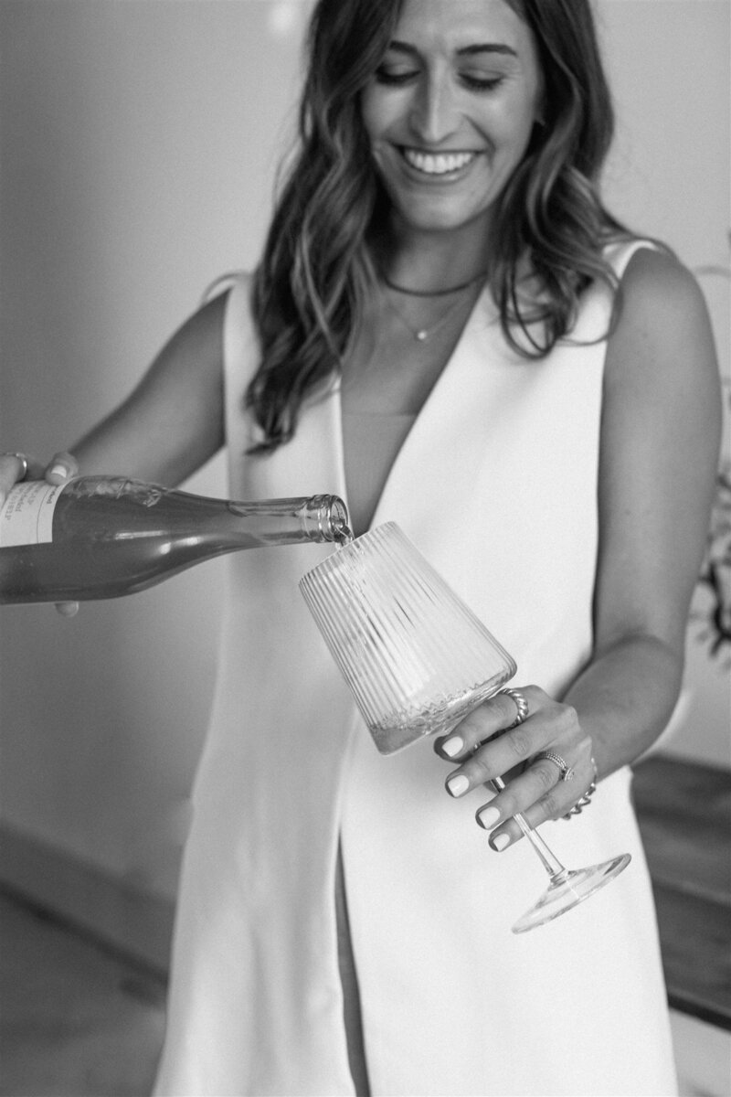 Kaitlyn Parker, copywriter and CU Founder pouring wine
