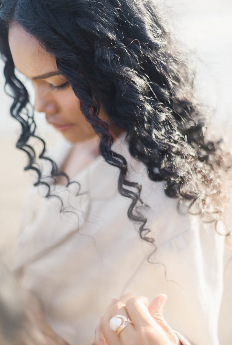 women close up with the sun in the background