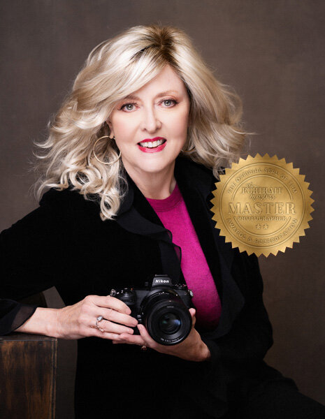 Photographer, Dana Chrysler, smiles for photos in black dress