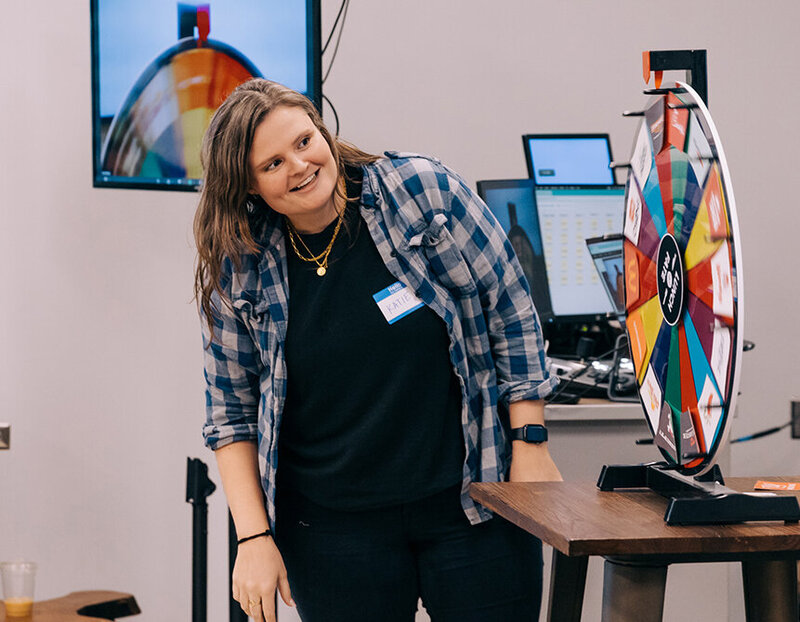 A group of women sit around a dining table smiling. 