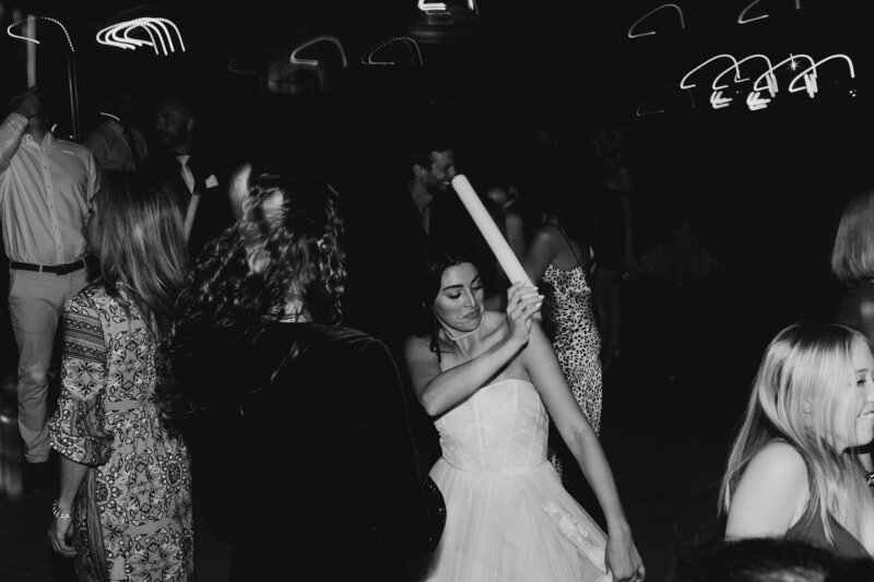 bride dancing at wedding reception in sleeveless wedding dress