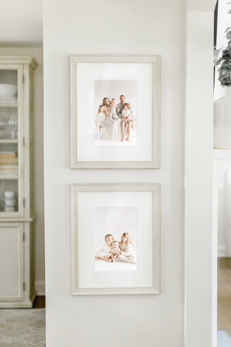 Framed photos on small nook in home.