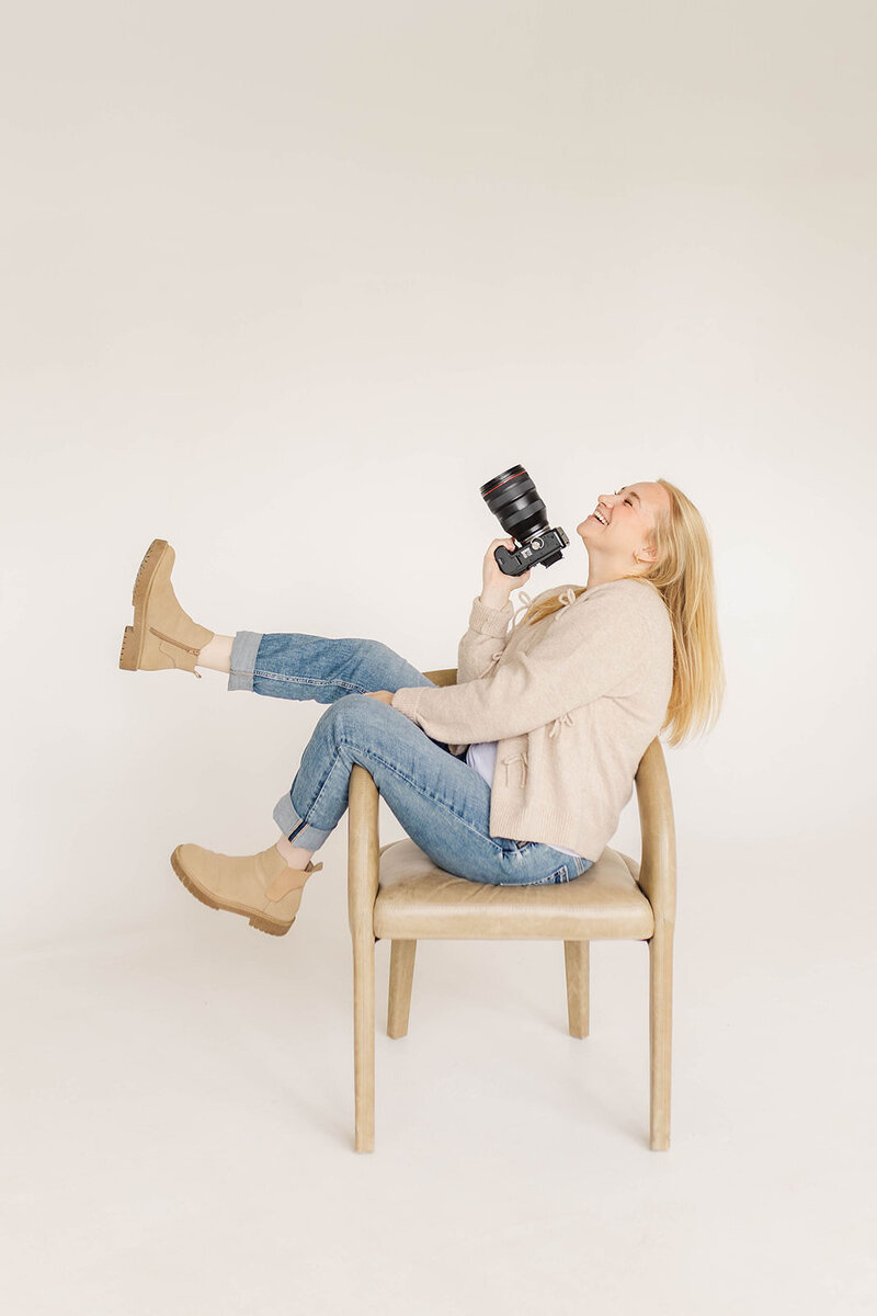 Jessica Nicole Photography smiling holding her camera ready to photograph your Colorado wedding.