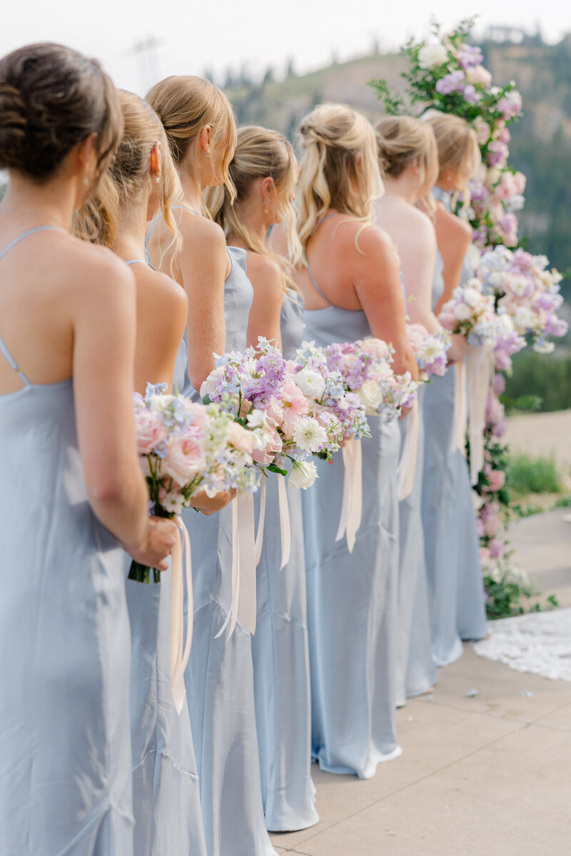 bridesmaids in blue standing in the ceremony
