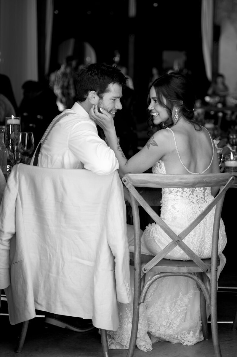 Photo of bride and groom sitting at the head table during their montana wedding at copper rose ranch
