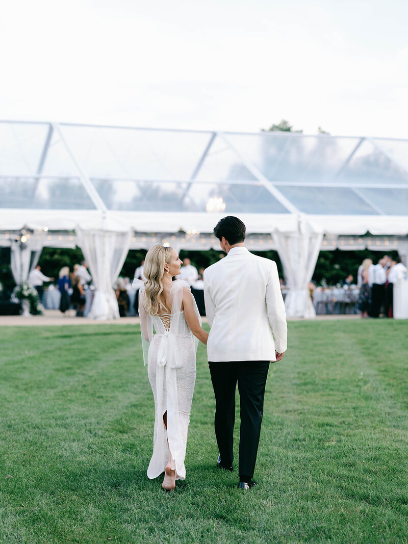 Couple walking back to their wedding reception