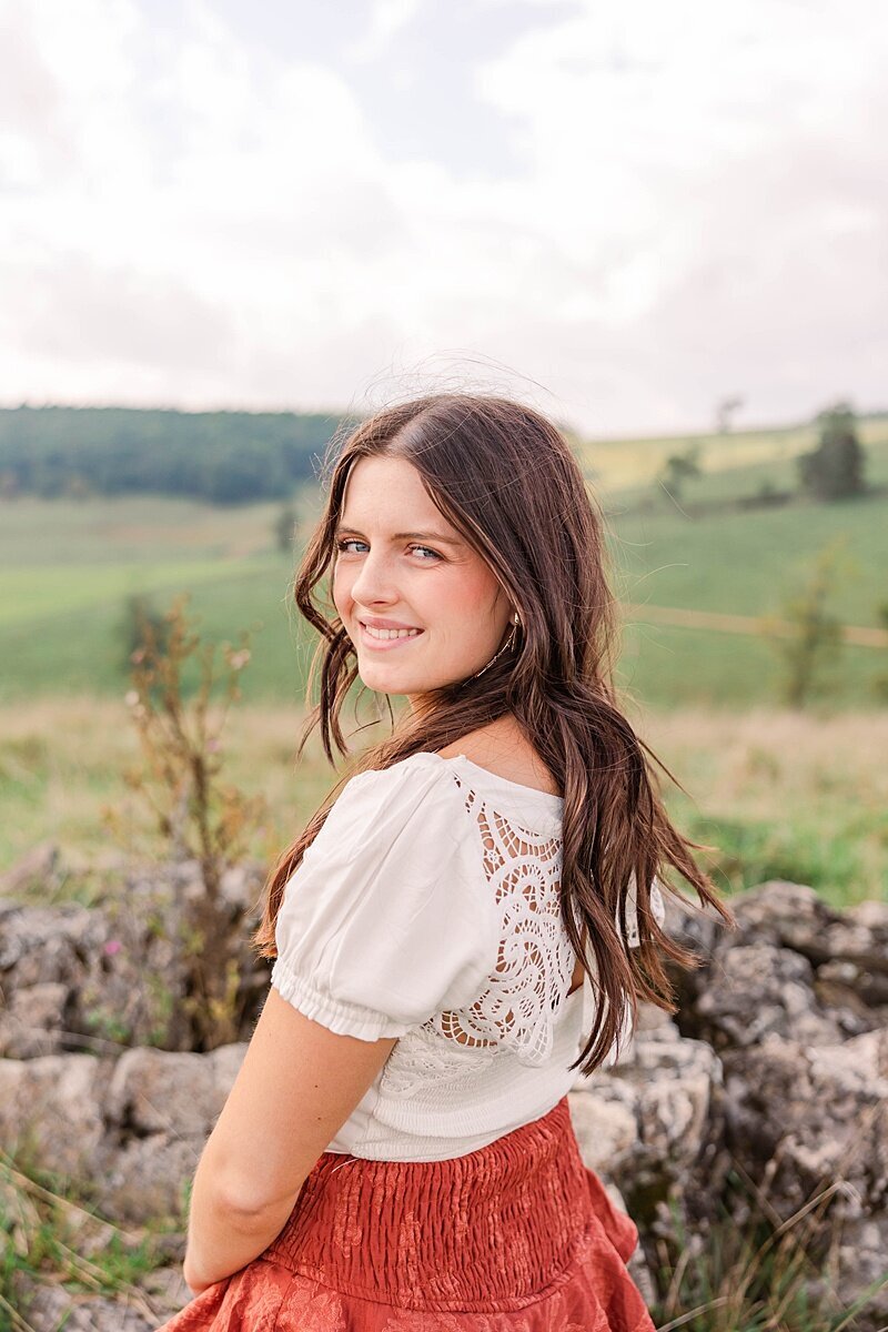 Senior posing confidently in a scenic outdoor location in Harrisonburg, VA, capturing personality and style