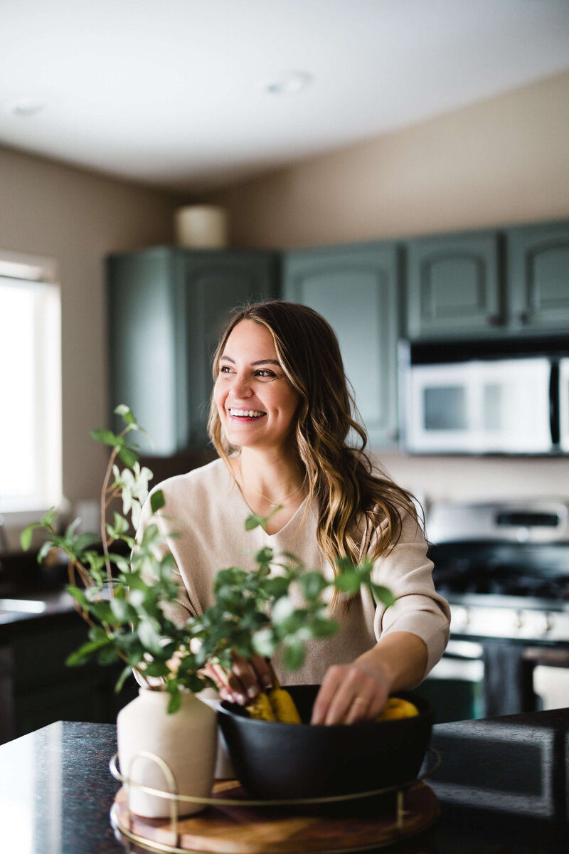 candid photo of woman laughing on a couch