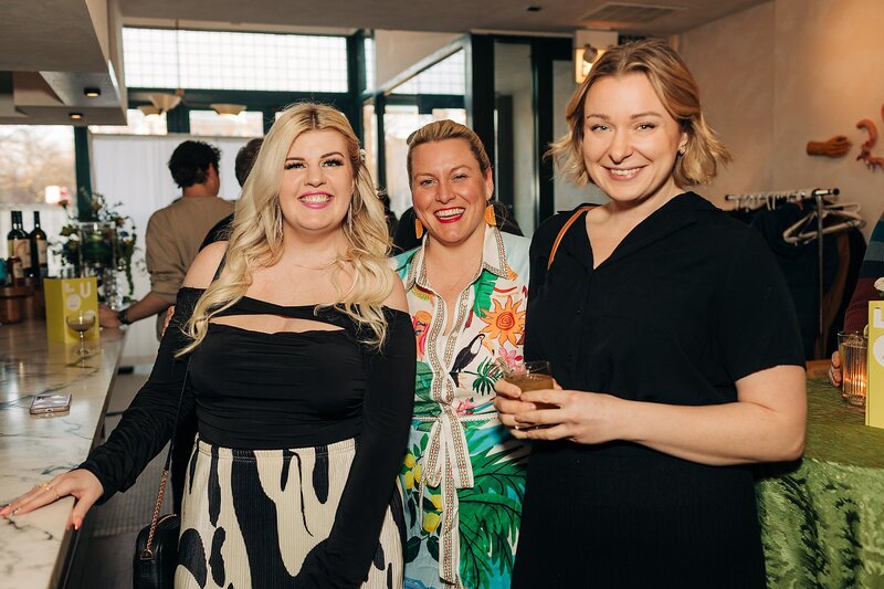 Friends toasting and celebrating during Dart Collective Chicago launch at Lou Lou by Lola Cafe