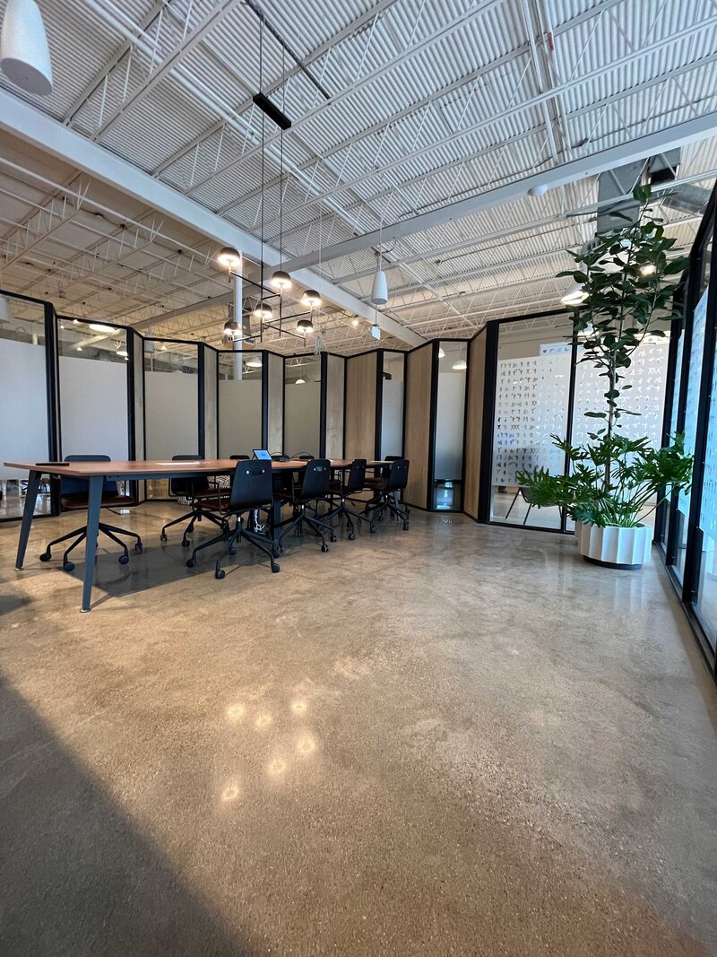 Best Concrete Polishing Company in Texas, offering high-quality services for commercial spaces. The image shows a sophisticated and beautifully decorated office with plants and office desks, reflecting years of expertise and top-tier materials.