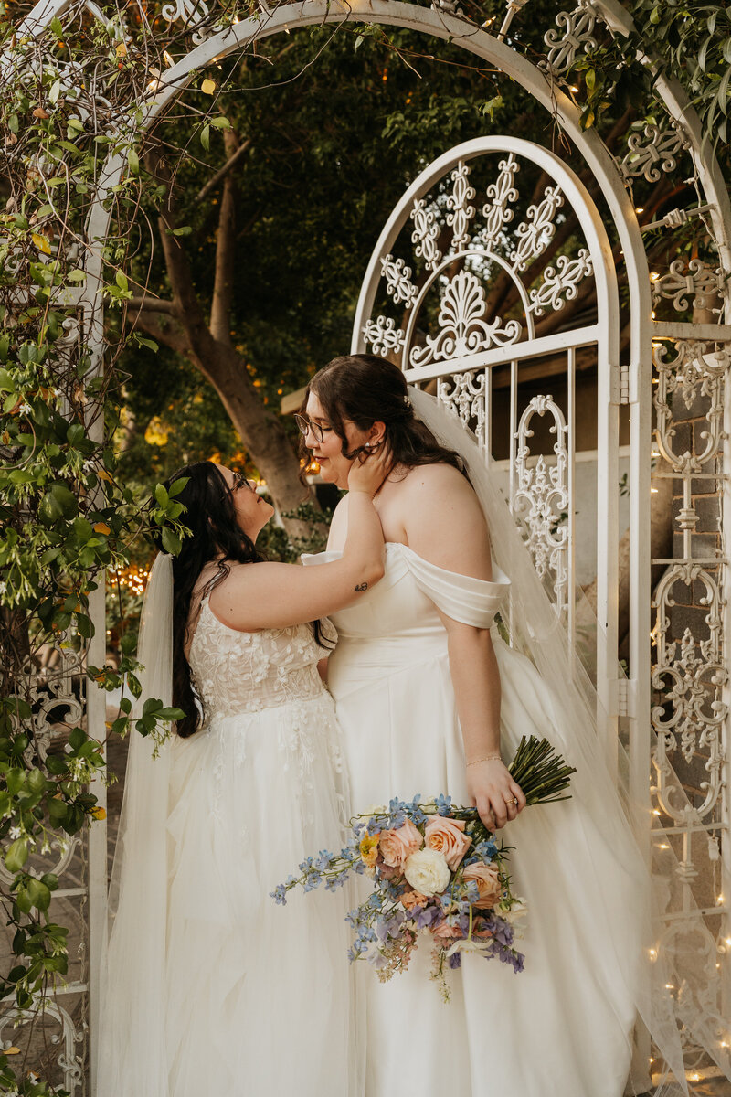 A person reaching up to kiss their partner on their wedding day 