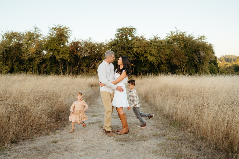 boy standing with parents