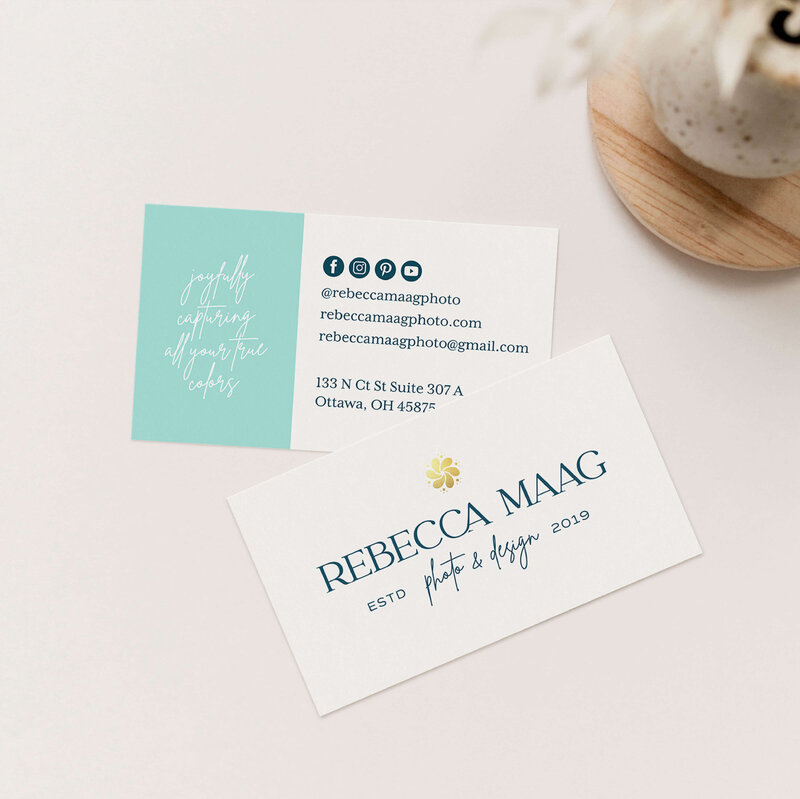 Cream colored business card design for wedding photographer with teal pop of color on neutral background