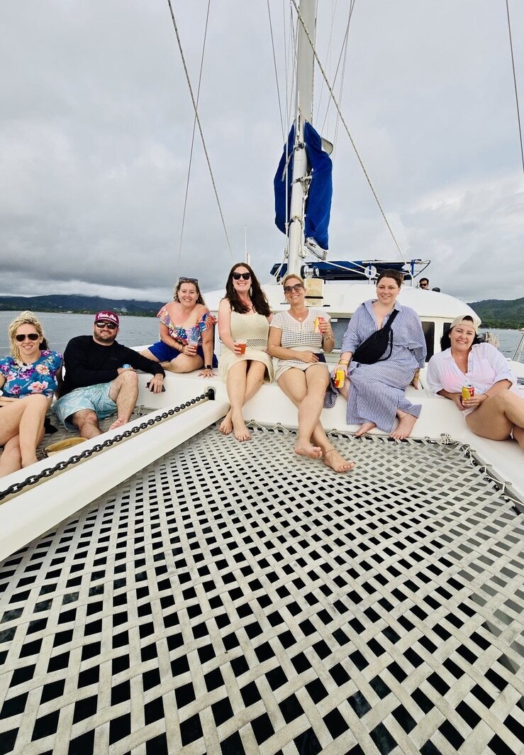 Dana sailing on a catamaran used for welcome events