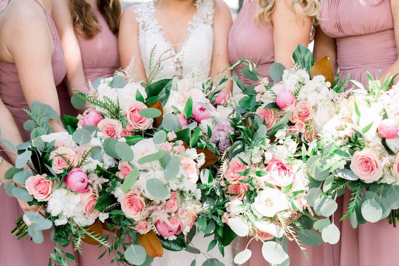 Closeup of wedding party's pink rose bouquets
