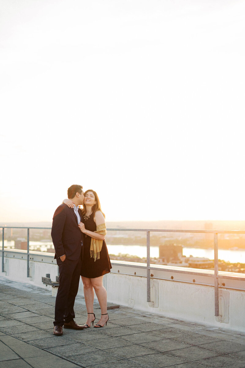 Romantic portrait of couple in golden hour light on during Boston Rooftop Proposal

