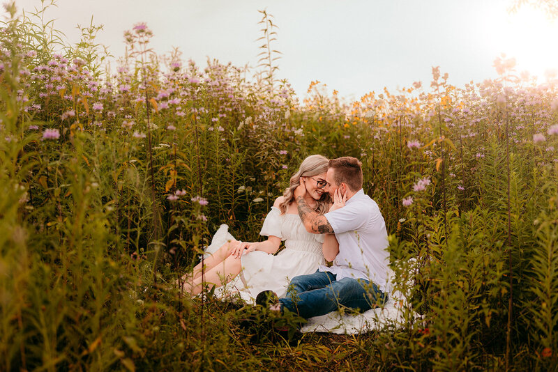 Couple sitting together in a field of flowers in St. Augustine, Florida.