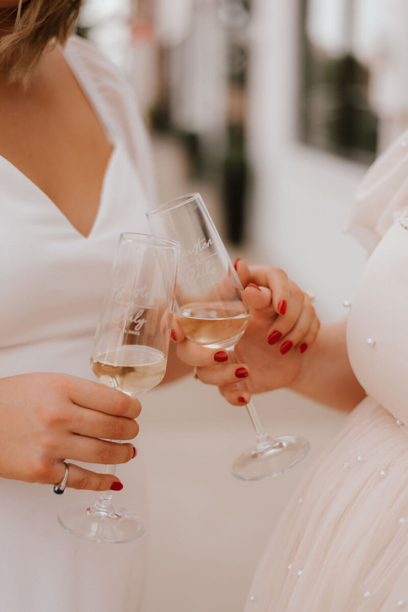 wedding couple holds champagne on wedding day in peoria il