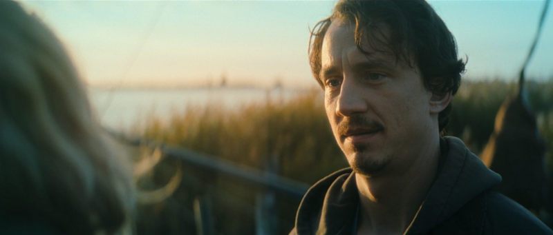 A vulnerable emotional moment during a therapy session, framed with intimacy.