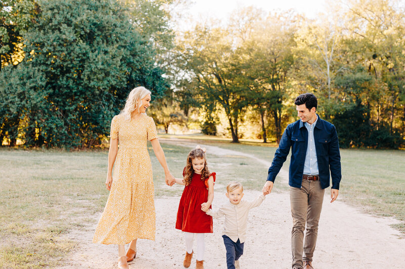 family holding hands and walking during a family session