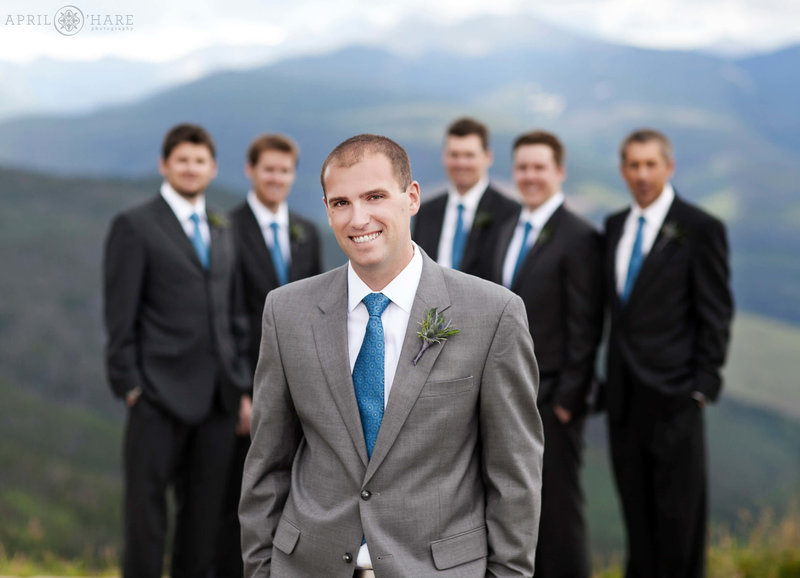 Groom portrait at Holy Cross Event Deck at Vail Resort on a stormy summer wedding day
