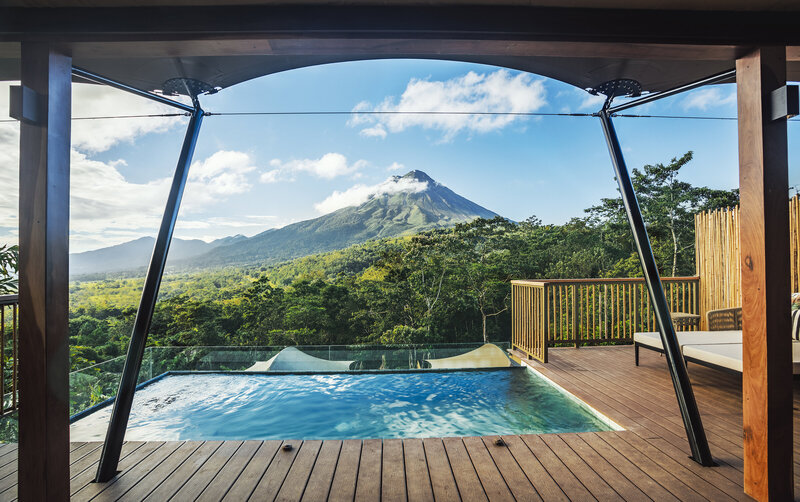 Pool at Nayara luxury tent hotel with view of Arenal volcano