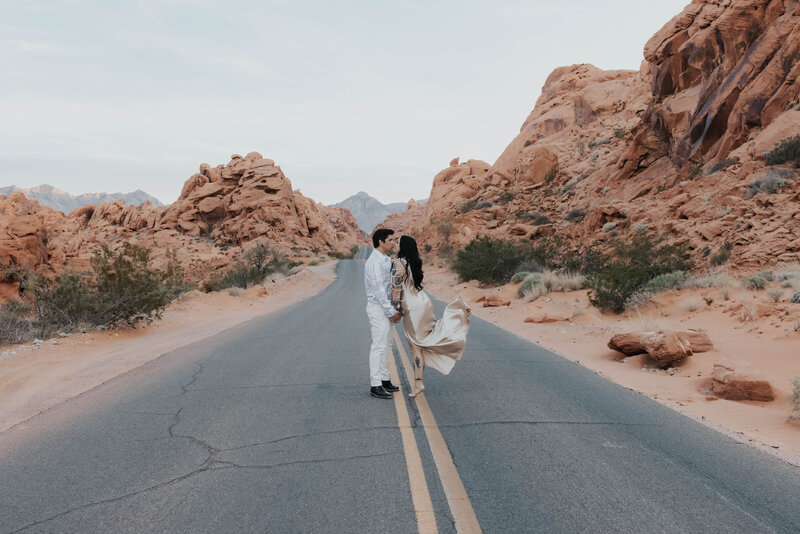 newlyweds kiss on road